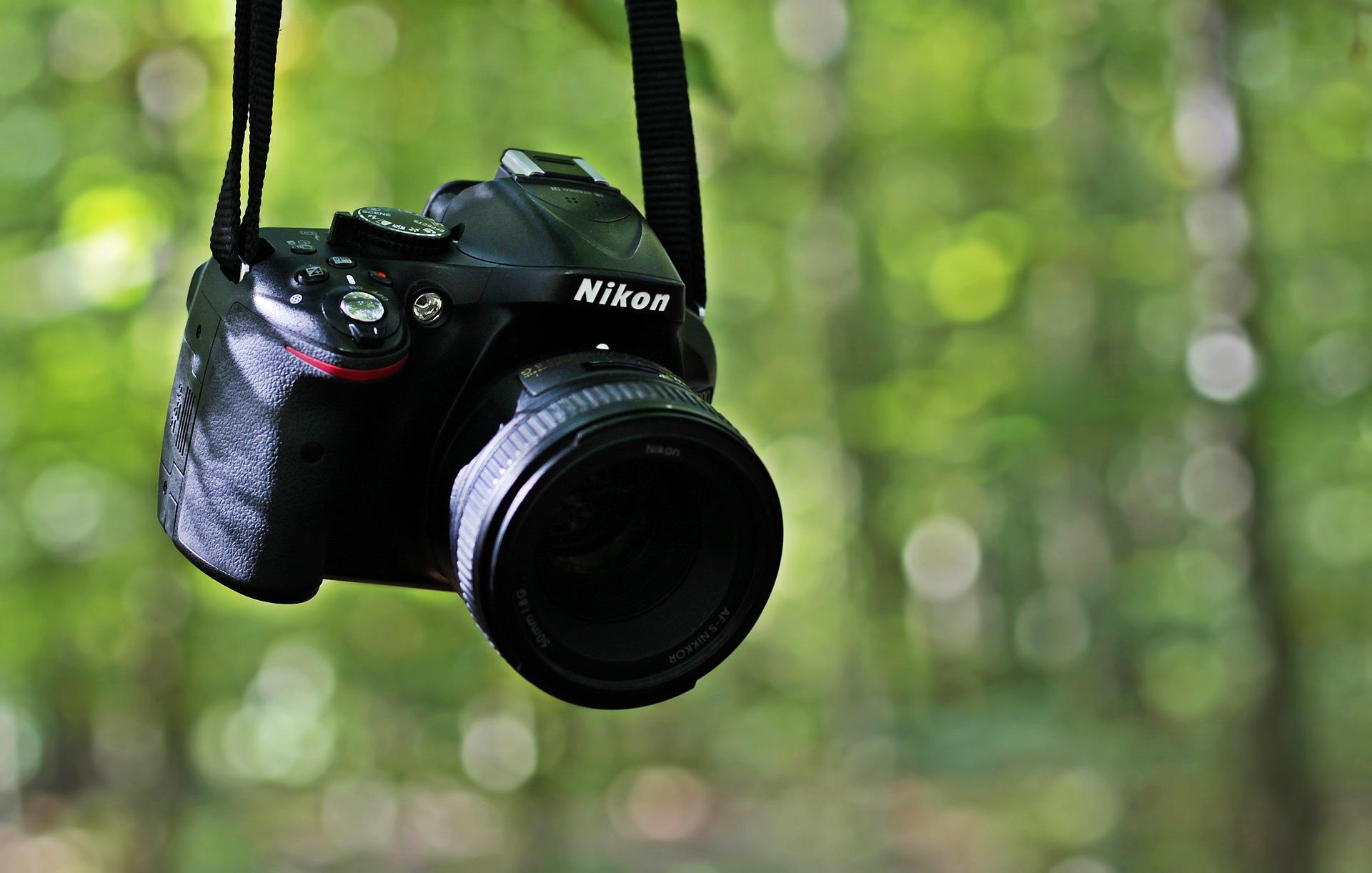 Nikon digital camera with blurred trees in background