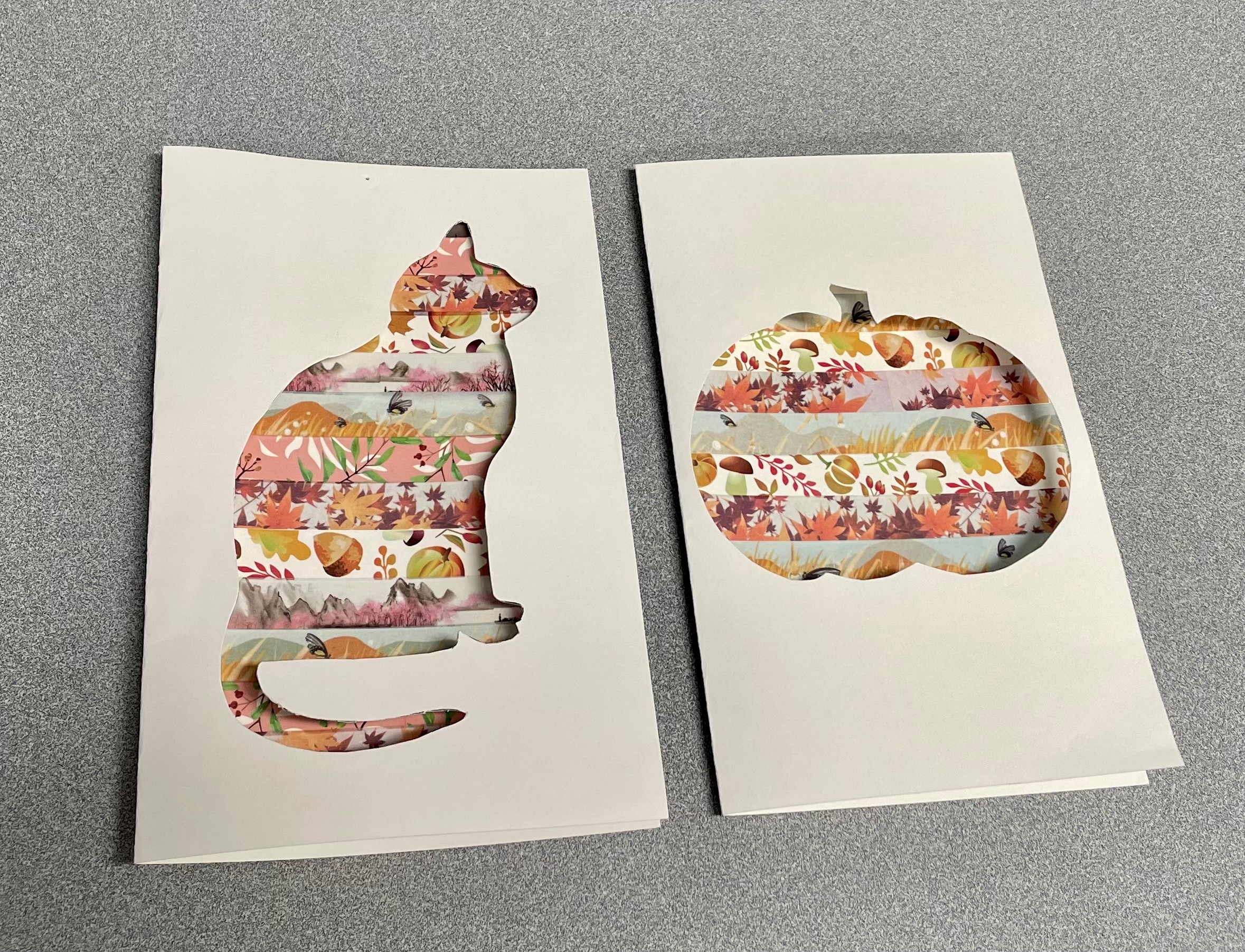Two examples of the finished washi tape craft: one card with a cat cutout and one card with a pumpkin cutout.