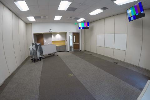 South meeting room B with open room setup and screen