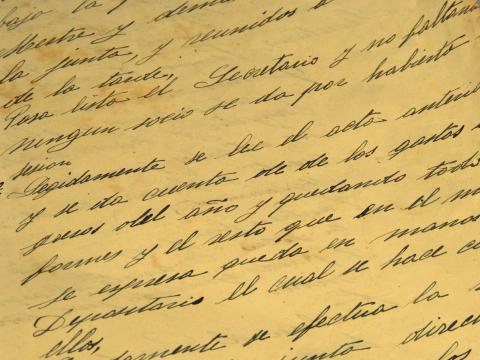 Spanish cursive writing on yellowed paper