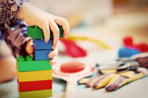 Child's hands building a block tower