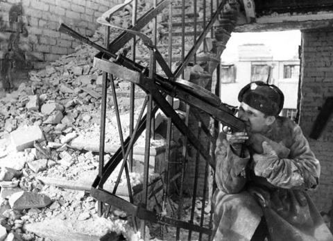 Soldier aims assault weapon in stairwell