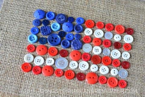 American flag made out of red, white and blue buttons of various sizes