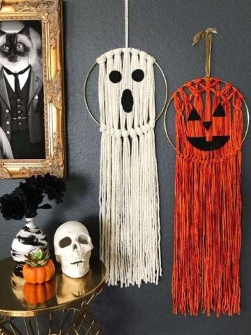 Two macrame Halloween decoration hanging on a wall.