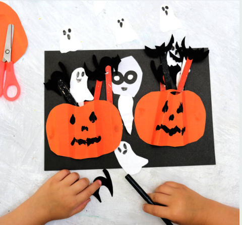 a childrens paper craft with pumpkins and ghosts