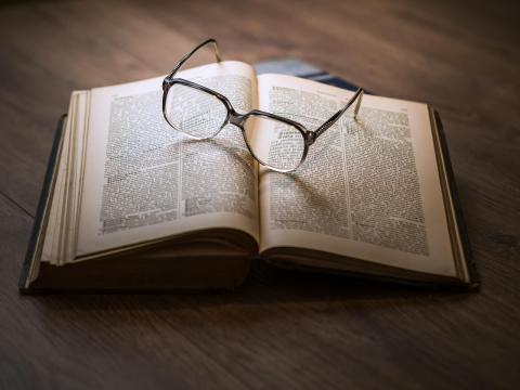 glasses on top of an open book