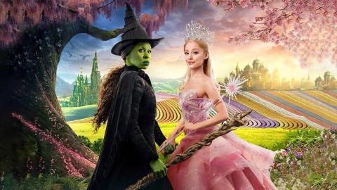 Wicked: Part I poster featuring Elphaba and Glinda with the land of Oz in the background.
