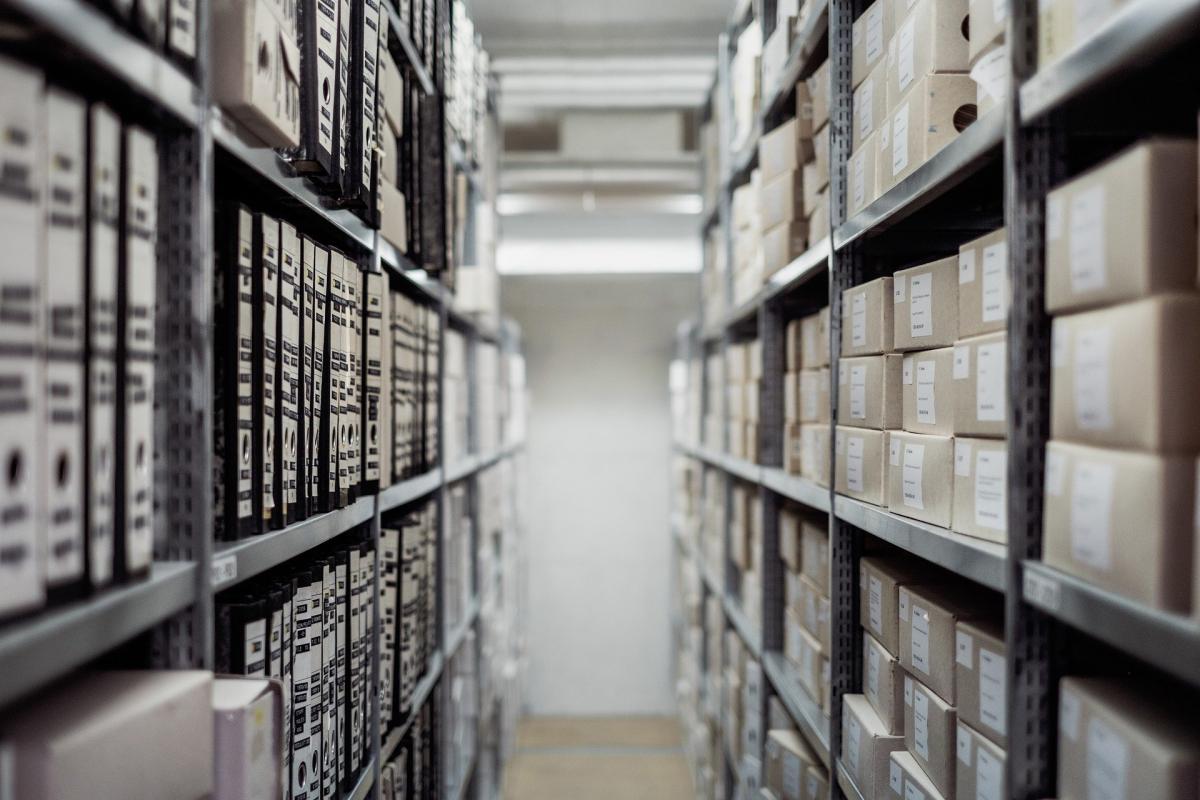 row of bookshelves containing boxes and files 