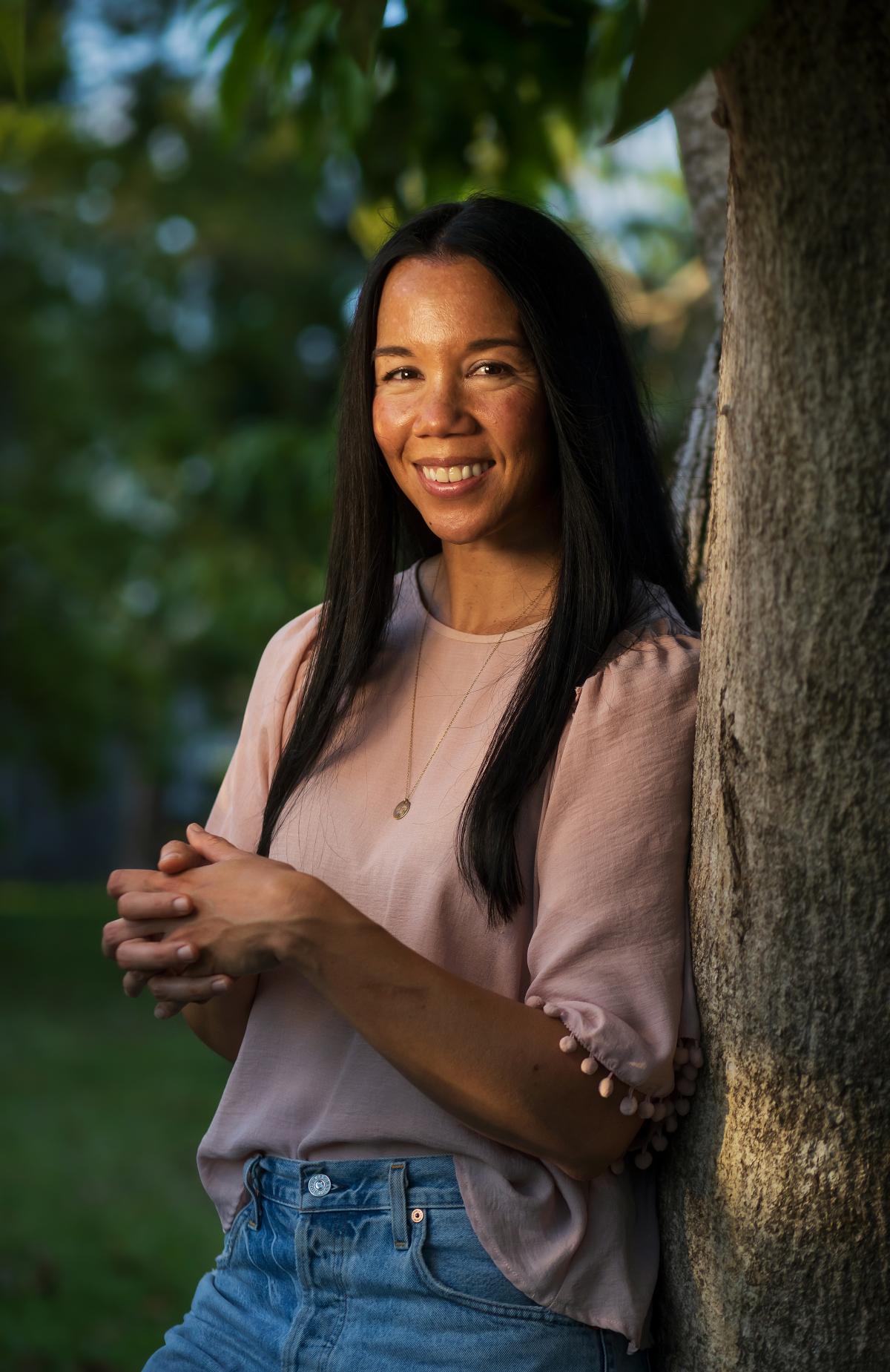 Annabelle Tometich leaning on a tree. 