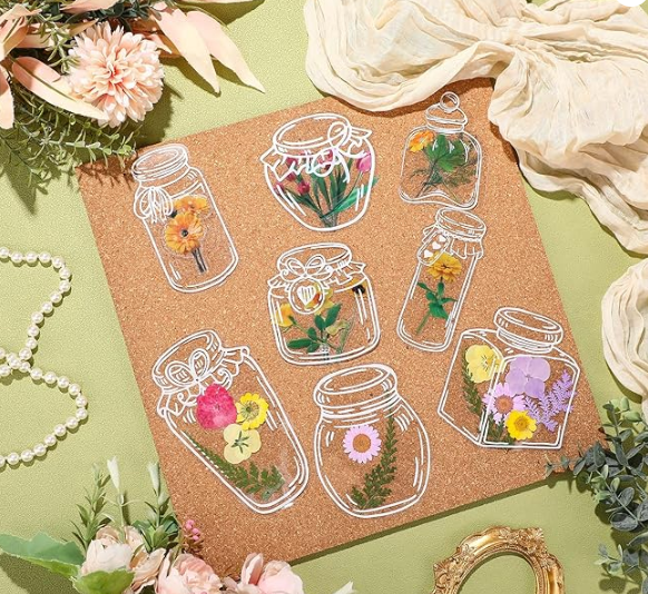Photo of botanical bookmarks, pressed flowers and leaves on jar-shaped bookmarks.