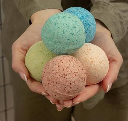 Hands holding bath bombs