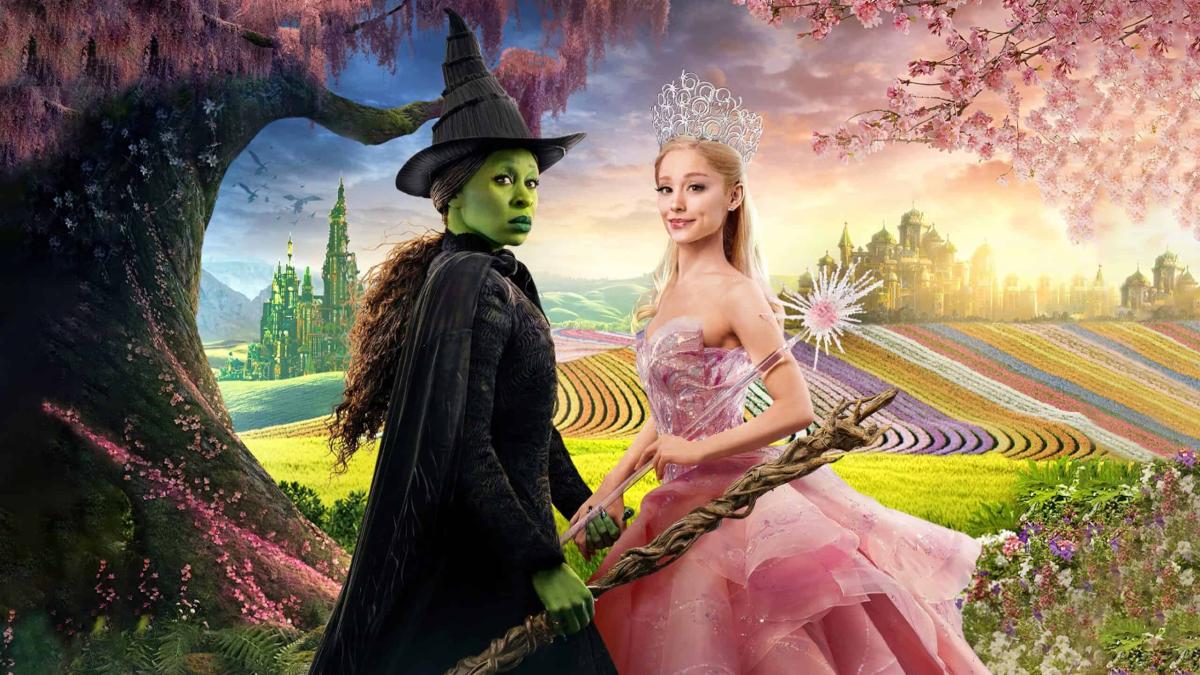 Wicked: Part I poster featuring Elphaba and Glinda with the land of Oz in the background.